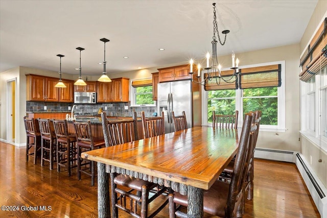15 Green Harbour Ln, Lake George, NY 12845 - dining area with a chandelier, dark wood-style floors, and a baseboard heating unit