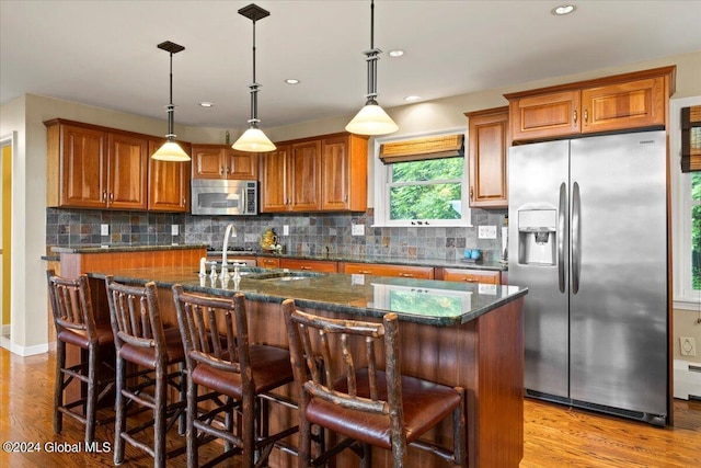 15 Green Harbour Ln, Lake George, NY 12845 - kitchen featuring appliances with stainless steel finishes, brown cabinets, light wood-style floors, and recessed lighting