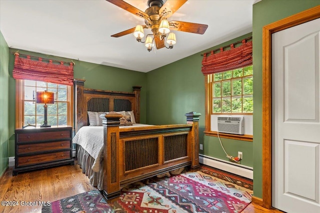 15 Green Harbour Ln, Lake George, NY 12845 - bedroom featuring a baseboard radiator, wood finished floors, cooling unit, and a ceiling fan