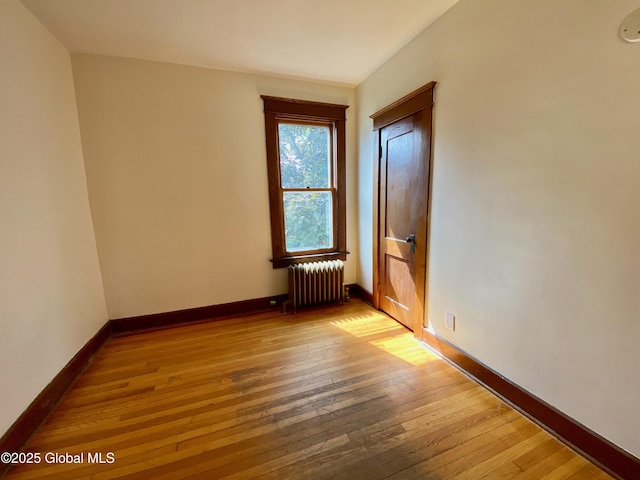 8 Mapleridge Ave, Albany, NY 12209 - empty room with radiator heating unit and hardwood / wood-style flooring