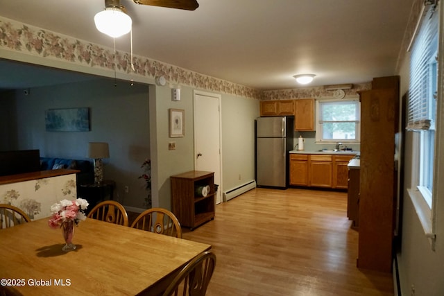 171 Consaul Rd, Colonie, NY 12205 - dining area featuring a baseboard heating unit, light wood-type flooring, and ceiling fan