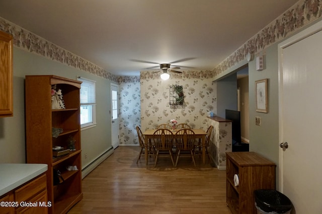 171 Consaul Rd, Colonie, NY 12205 - dining space with baseboard heating, wallpapered walls, wood finished floors, and ceiling fan