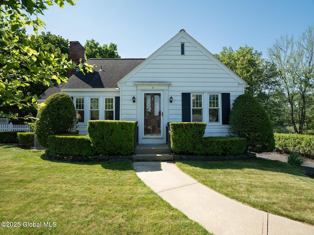 2 Arthur Rd, Colonie, NY 12110 - view of front of house with a chimney, a front lawn, and roof with shingles
