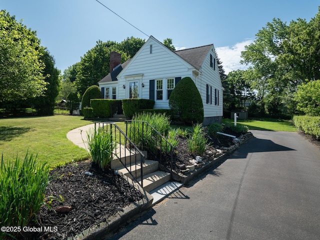 2 Arthur Rd, Colonie, NY 12110 - bungalow-style home featuring a chimney and a front lawn