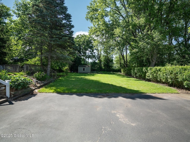 2 Arthur Rd, Colonie, NY 12110 - view of green lawn with a storage unit and a patio