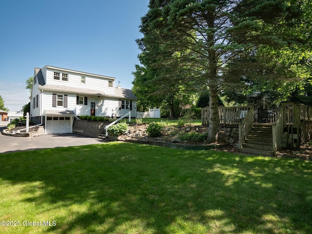 2 Arthur Rd, Colonie, NY 12110 - view of green lawn with stairs, driveway, an attached garage, and a wooden deck