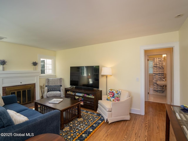 2 Arthur Rd, Colonie, NY 12110 - living room with light wood-style floors and a brick fireplace