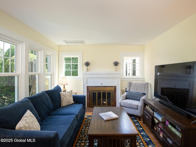 2 Arthur Rd, Colonie, NY 12110 - living area with a brick fireplace and wood finished floors