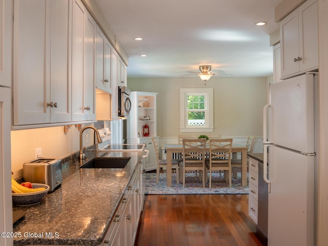 2 Arthur Rd, Colonie, NY 12110 - kitchen featuring freestanding refrigerator, stainless steel microwave, dark wood-style flooring, ceiling fan, and white cabinetry