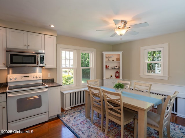 2 Arthur Rd, Colonie, NY 12110 - kitchen featuring stainless steel microwave, white range with electric cooktop, healthy amount of natural light, radiator heating unit, and recessed lighting