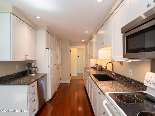 2 Arthur Rd, Colonie, NY 12110 - kitchen with stainless steel appliances, recessed lighting, white cabinets, dark wood finished floors, and dark stone countertops