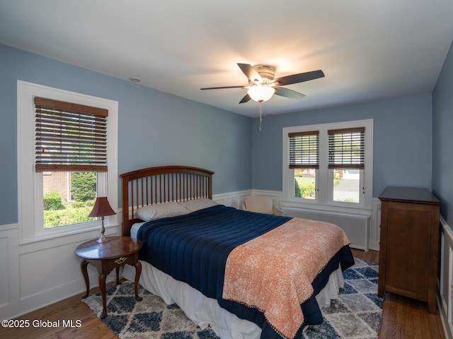 2 Arthur Rd, Colonie, NY 12110 - bedroom with radiator, a wainscoted wall, wood finished floors, and ceiling fan