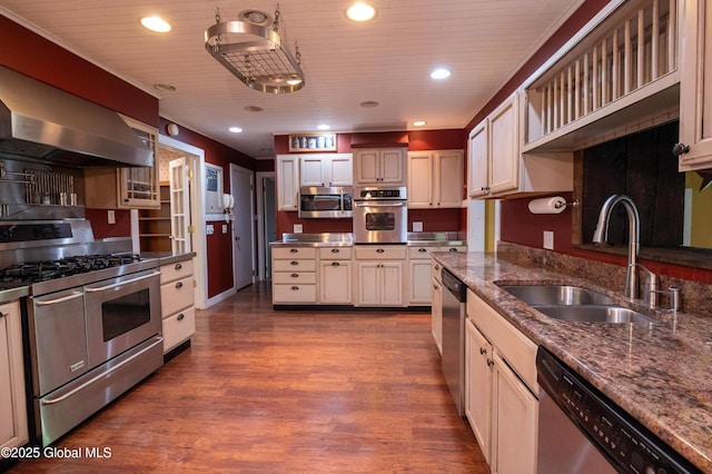19 Meadow Rd, Hudson Falls, NY 12839 - kitchen featuring appliances with stainless steel finishes, wall chimney exhaust hood, dark wood-style flooring, recessed lighting, and dark stone countertops