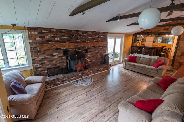 19 Meadow Rd, Hudson Falls, NY 12839 - living room with a wood stove, wood finished floors, and brick wall