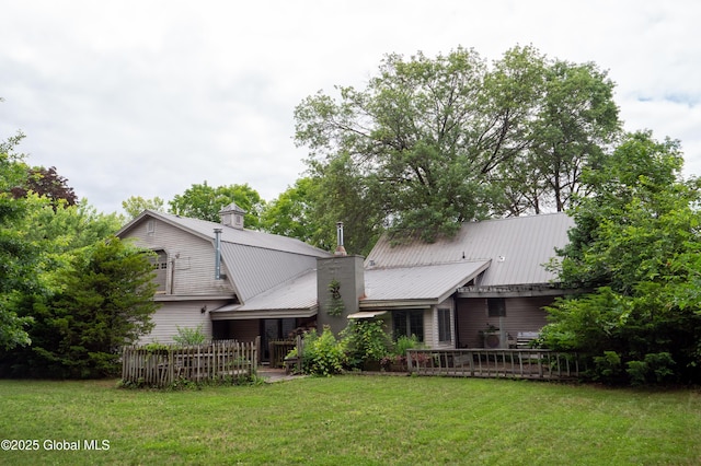 19 Meadow Rd, Hudson Falls, NY 12839 - back of house featuring a chimney, a yard, and a metal roof