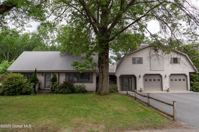 19 Meadow Rd, Hudson Falls, NY 12839 - colonial inspired home with a gambrel roof, a front yard, asphalt driveway, a garage, and a metal roof