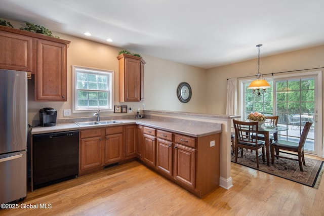 16 Callaway Cir, Colonie, NY 12211 - kitchen featuring dishwasher, freestanding refrigerator, brown cabinetry, a peninsula, and light wood-style flooring