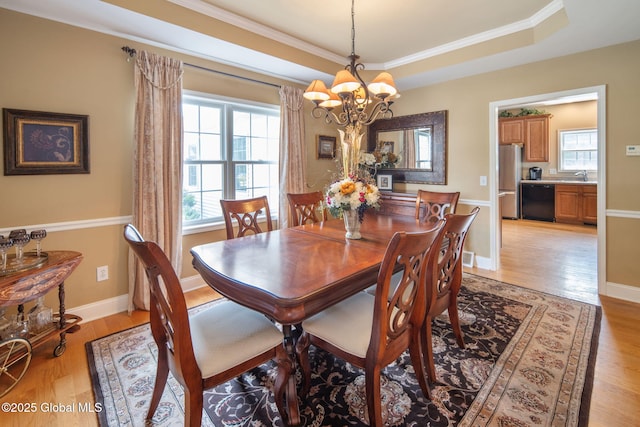 16 Callaway Cir, Colonie, NY 12211 - dining space with a chandelier, light wood-type flooring, a raised ceiling, and ornamental molding