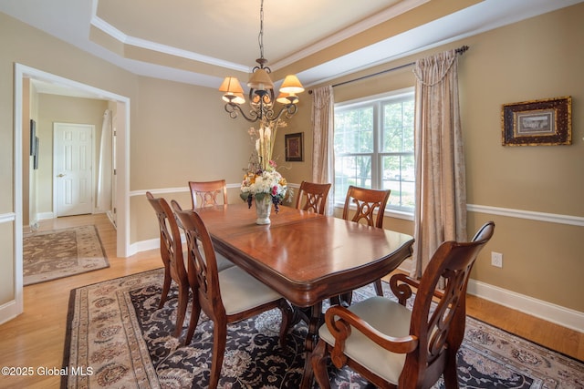 16 Callaway Cir, Colonie, NY 12211 - dining space featuring a chandelier, light wood finished floors, a raised ceiling, and ornamental molding