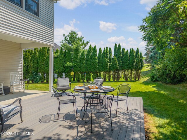 16 Callaway Cir, Colonie, NY 12211 - wooden deck with outdoor dining area, a lawn, and view of wooded area
