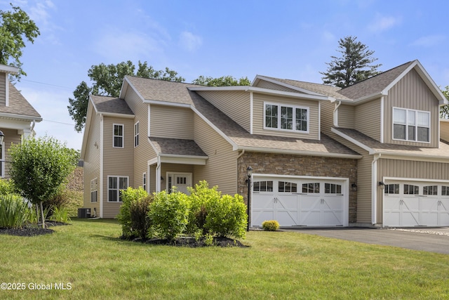 10A Idared Ln, Halfmoon, NY 12065 - view of front of house featuring asphalt driveway, a front yard, a garage, and roof with shingles