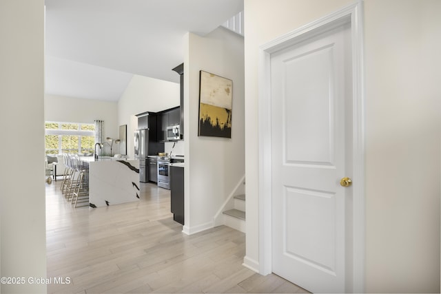 10A Idared Ln, Halfmoon, NY 12065 - corridor with light wood-type flooring, stairs, and high vaulted ceiling
