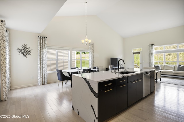 10A Idared Ln, Halfmoon, NY 12065 - kitchen with a chandelier, high vaulted ceiling, stainless steel dishwasher, open floor plan, and a center island with sink