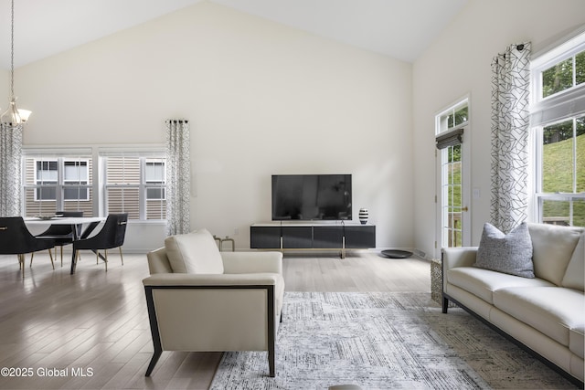 10A Idared Ln, Halfmoon, NY 12065 - living room with high vaulted ceiling, wood finished floors, and a chandelier
