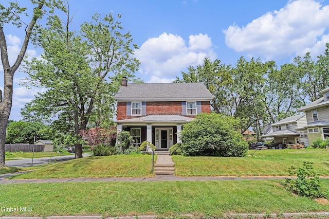 1101 Ardsley Rd, Schenectady, NY 12308 - view of front of home with brick siding, a chimney, and a front lawn