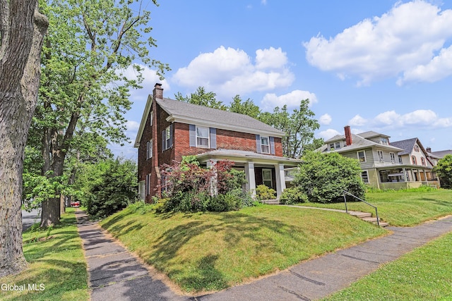 1101 Ardsley Rd, Schenectady, NY 12308 - view of front of home with brick siding, a front yard, and a chimney