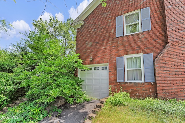 1101 Ardsley Rd, Schenectady, NY 12308 - view of property exterior with an attached garage and brick siding