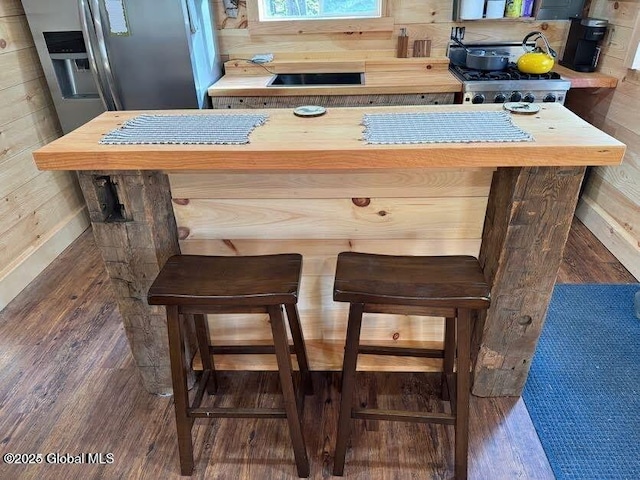 215 Ridge Rd, Minerva, NY 12851 - detailed view of wood finished floors, stainless steel refrigerator with ice dispenser, and wood walls
