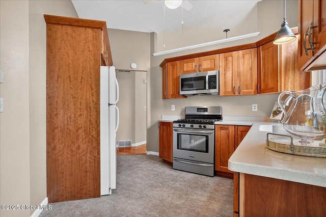 13 Hyland Cir, Troy, NY 12182 - kitchen with appliances with stainless steel finishes, brown cabinets, light countertops, and a ceiling fan