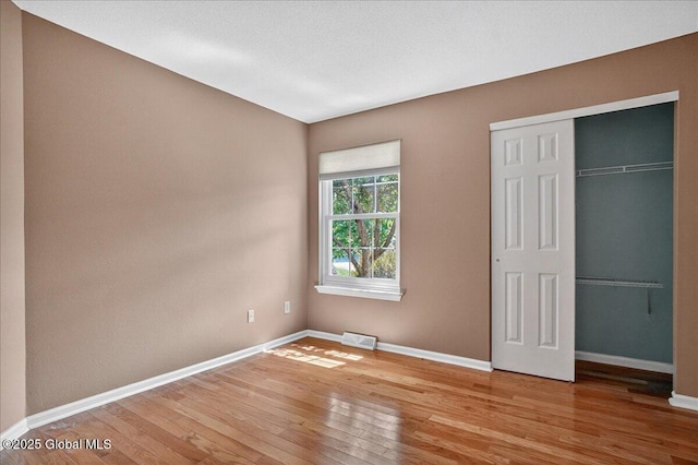 13 Hyland Cir, Troy, NY 12182 - unfurnished bedroom with light wood-style floors and a closet