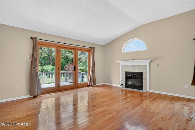 13 Hyland Cir, Troy, NY 12182 - unfurnished living room with lofted ceiling, healthy amount of natural light, light wood-type flooring, and a fireplace