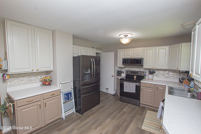 33 Woodside Dr, Glenville, NY 12302 - kitchen featuring stainless steel appliances, decorative backsplash, light countertops, and light wood-type flooring