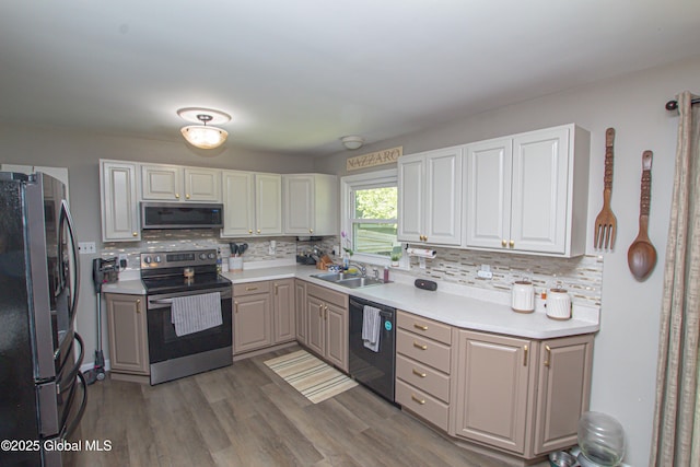 33 Woodside Dr, Glenville, NY 12302 - kitchen featuring appliances with stainless steel finishes, tasteful backsplash, wood finished floors, and light countertops