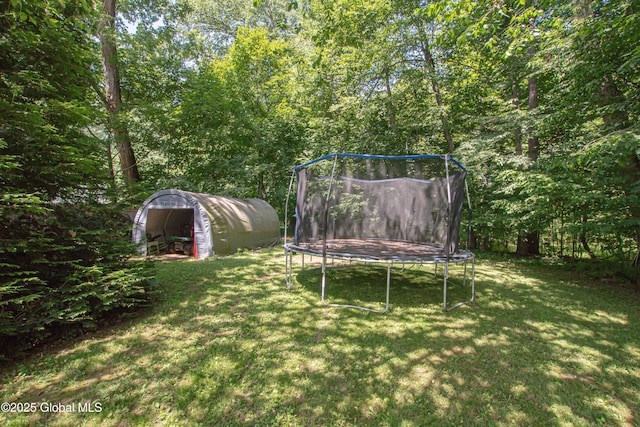 33 Woodside Dr, Glenville, NY 12302 - view of grassy yard featuring a trampoline and a shed