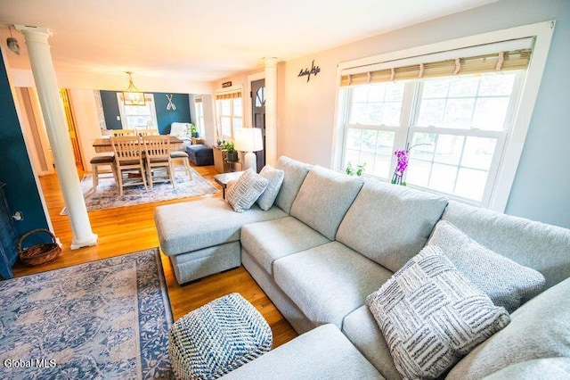 1264 Pilot Knob Rd, Fort Ann, NY 12844 - living area with wood finished floors, decorative columns, and a chandelier