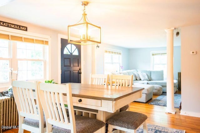 1264 Pilot Knob Rd, Fort Ann, NY 12844 - dining space with wood finished floors, ornate columns, and radiator heating unit
