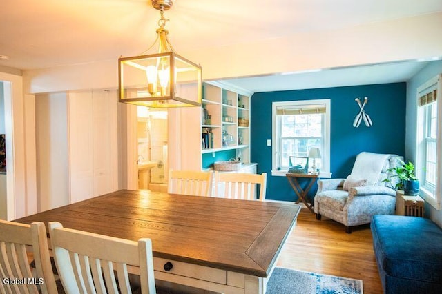 1264 Pilot Knob Rd, Fort Ann, NY 12844 - dining area featuring healthy amount of natural light, wood finished floors, and a chandelier