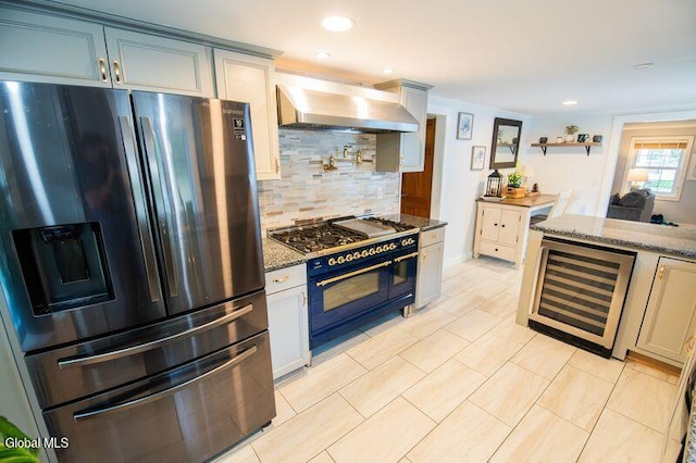 1264 Pilot Knob Rd, Fort Ann, NY 12844 - kitchen featuring stainless steel appliances, wall chimney exhaust hood, wine cooler, stone counters, and tasteful backsplash