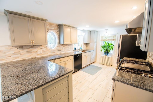 1264 Pilot Knob Rd, Fort Ann, NY 12844 - kitchen with radiator, dishwasher, wall chimney range hood, backsplash, and plenty of natural light