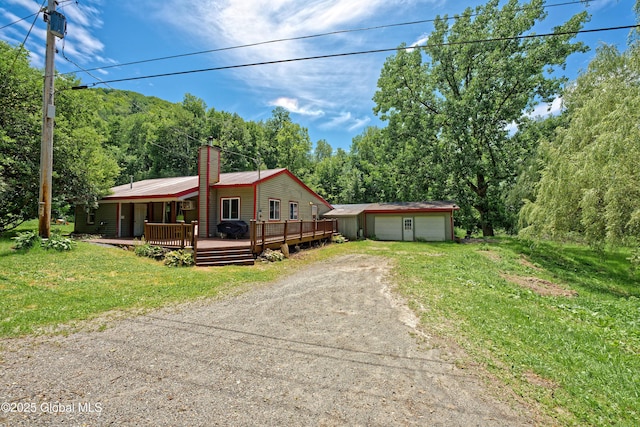 962 Camden Valley Rd, Salem, NY 12873 - view of front facade with dirt driveway, an outbuilding, a deck, a detached garage, and a chimney