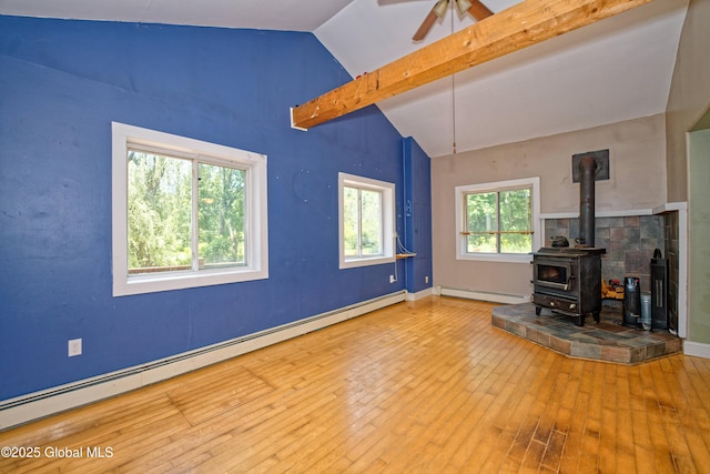 962 Camden Valley Rd, Salem, NY 12873 - unfurnished living room featuring a baseboard heating unit, a wood stove, wood-type flooring, beam ceiling, and a ceiling fan