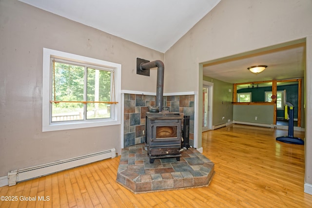 962 Camden Valley Rd, Salem, NY 12873 - unfurnished living room with baseboard heating, a wood stove, wood-type flooring, a baseboard radiator, and lofted ceiling