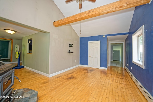 962 Camden Valley Rd, Salem, NY 12873 - living area with a baseboard radiator, a wood stove, ceiling fan, light wood-style flooring, and beamed ceiling