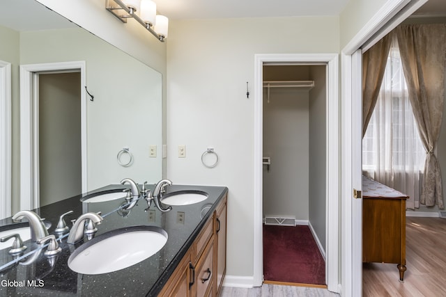 1 Maple Dr, Greenfield, NY 12833 - bathroom featuring wood finished floors, double vanity, and a spacious closet