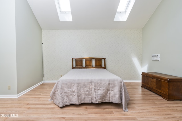 1 Maple Dr, Greenfield, NY 12833 - bedroom featuring a skylight, wood finished floors, wallpapered walls, and vaulted ceiling