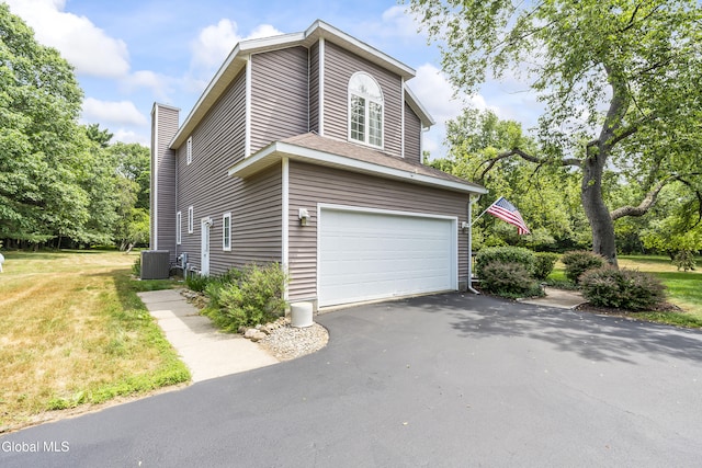1 Maple Dr, Greenfield, NY 12833 - view of side of home featuring driveway, a garage, a chimney, and a lawn